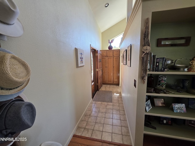 5665 Tannerwood Dr, Reno, NV 89511 - hall with vaulted ceiling, light tile patterned flooring, and baseboards