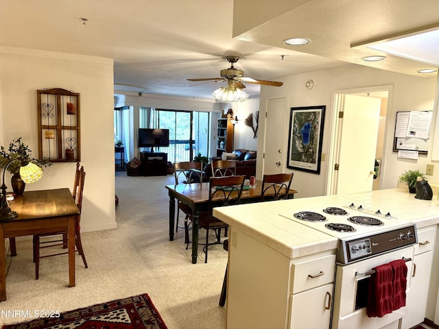 333 Ski Way Unit 274, Incline Village, NV 89451 - kitchen featuring tile counters, light carpet, a ceiling fan, white cabinets, and open floor plan