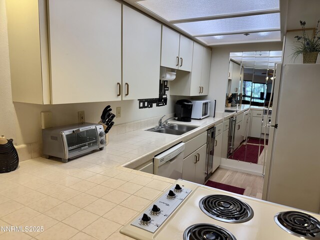 333 Ski Way Unit 274, Incline Village, NV 89451 - kitchen featuring a sink, white appliances, tile countertops, white cabinets, and light wood-style flooring