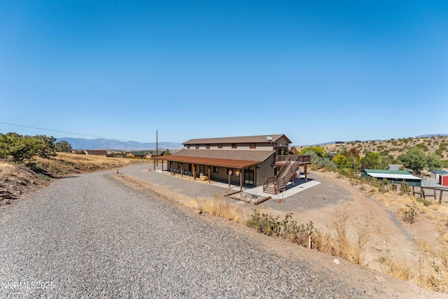2620 Old Ranch Rd, Gardnerville, NV 89410 - view of front of home featuring stairway, a deck with mountain view, a patio, and driveway