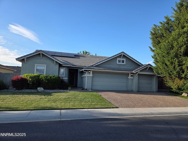 1388 Lambrays Ln, Sparks, NV 89436 - view of front of property with a garage, decorative driveway, roof mounted solar panels, stucco siding, and a tile roof