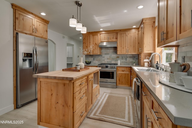 471 Kent Way, Zephyr Cove, NV 89448 - kitchen with appliances with stainless steel finishes, under cabinet range hood, wood counters, a sink, and a center island