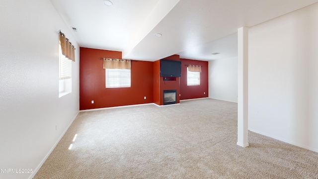 193 Maple Ave, Winnemucca, NV 89445 - unfurnished living room featuring carpet flooring, baseboards, and a glass covered fireplace