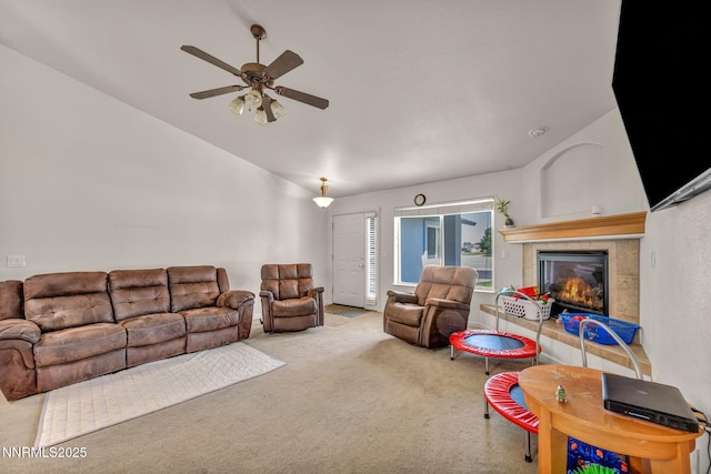 753 Divot Dr, Fernley, NV 89408 - carpeted living room with a tile fireplace, ceiling fan, and lofted ceiling