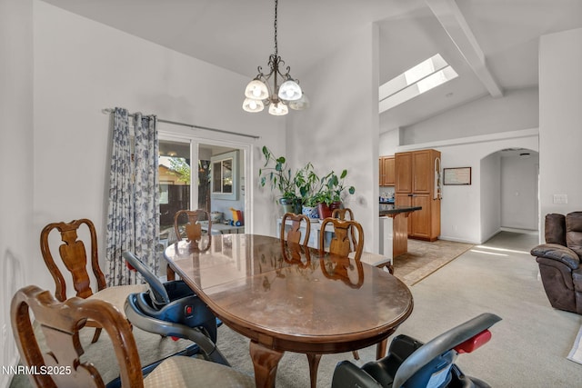 753 Divot Dr, Fernley, NV 89408 - dining space with beamed ceiling, light colored carpet, arched walkways, a skylight, and a chandelier