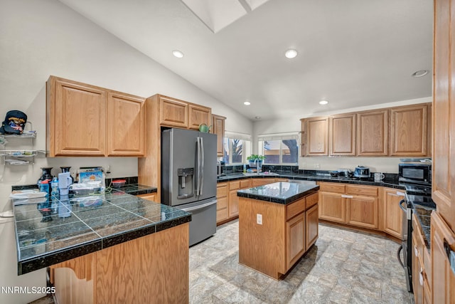 753 Divot Dr, Fernley, NV 89408 - kitchen featuring stainless steel fridge, tile countertops, black microwave, lofted ceiling, and recessed lighting