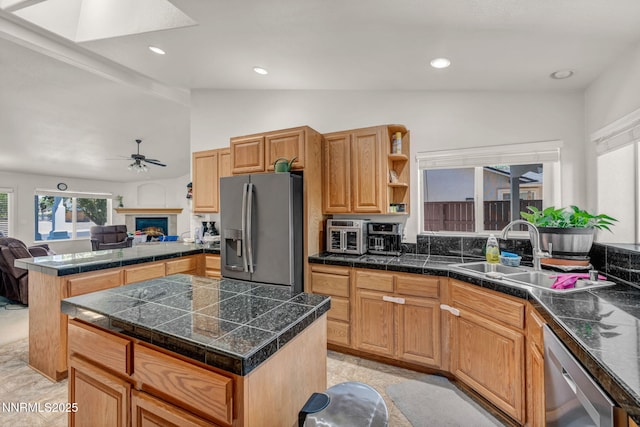 753 Divot Dr, Fernley, NV 89408 - kitchen with appliances with stainless steel finishes, a sink, ceiling fan, open floor plan, and a lit fireplace