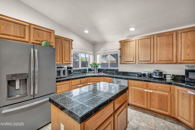 753 Divot Dr, Fernley, NV 89408 - kitchen with appliances with stainless steel finishes, lofted ceiling, tile counters, recessed lighting, and a sink