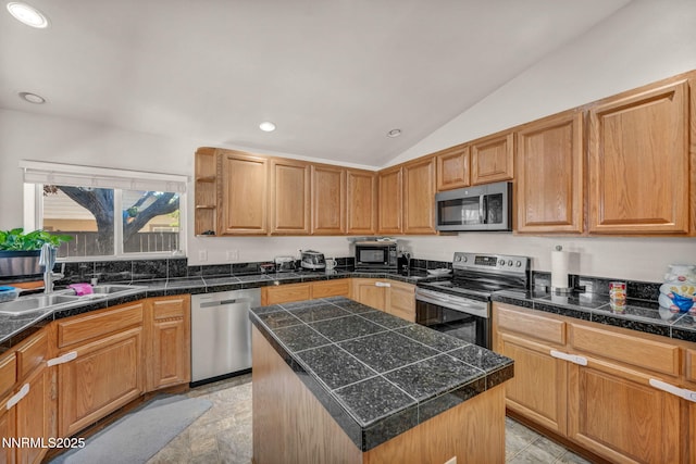 753 Divot Dr, Fernley, NV 89408 - kitchen featuring appliances with stainless steel finishes, tile countertops, a sink, vaulted ceiling, and recessed lighting
