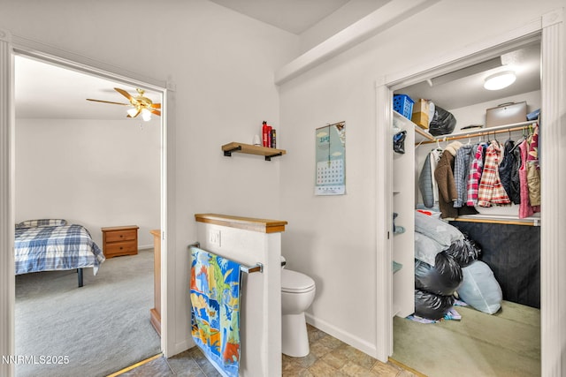 753 Divot Dr, Fernley, NV 89408 - bathroom featuring toilet, baseboards, a walk in closet, and a ceiling fan