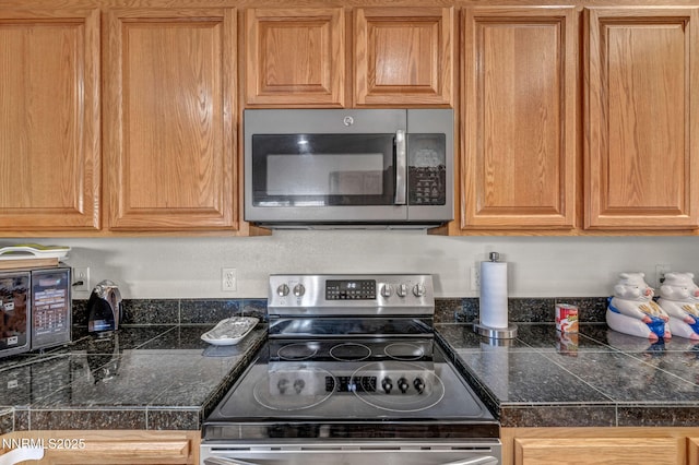 753 Divot Dr, Fernley, NV 89408 - kitchen with stainless steel appliances and tile countertops