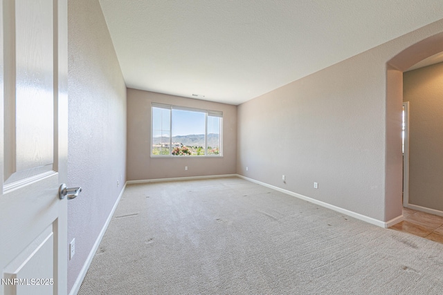 8890 Chipshot Trl, Reno, NV 89523 - empty room with light carpet, arched walkways, and baseboards