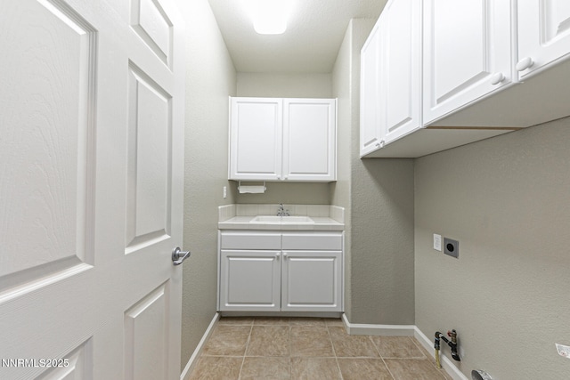 8890 Chipshot Trl, Reno, NV 89523 - laundry area featuring baseboards, electric dryer hookup, cabinet space, and light tile patterned floors