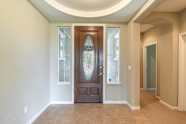 8890 Chipshot Trl, Reno, NV 89523 - foyer with baseboards, arched walkways, and light tile patterned floors