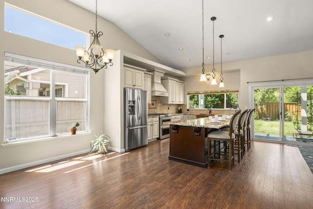 9783 Northrup Dr, Reno, NV 89521 - kitchen with appliances with stainless steel finishes, a chandelier, lofted ceiling, dark wood finished floors, and decorative backsplash