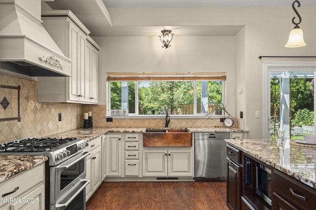 9783 Northrup Dr, Reno, NV 89521 - kitchen with appliances with stainless steel finishes, custom exhaust hood, light stone countertops, dark wood-style flooring, and backsplash