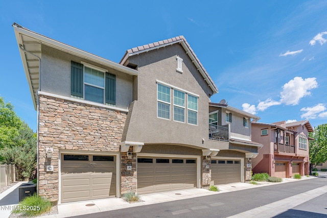 1875 Wind Ranch Rd Unit A, Reno, NV 89521 - view of front facade with stone siding, stucco siding, a garage, and central AC