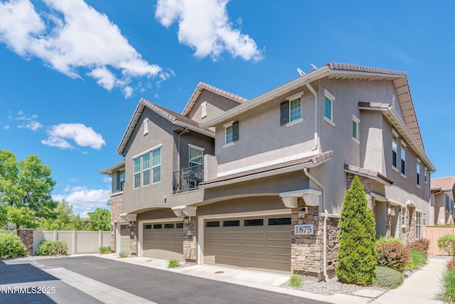 1875 Wind Ranch Rd Unit A, Reno, NV 89521 - view of front facade featuring stone siding, an attached garage, stucco siding, and asphalt driveway
