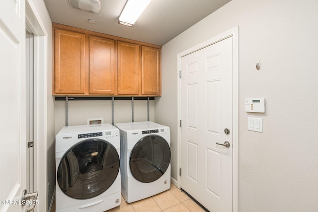 1875 Wind Ranch Rd Unit A, Reno, NV 89521 - laundry room featuring cabinet space, washing machine and dryer, and light tile patterned floors