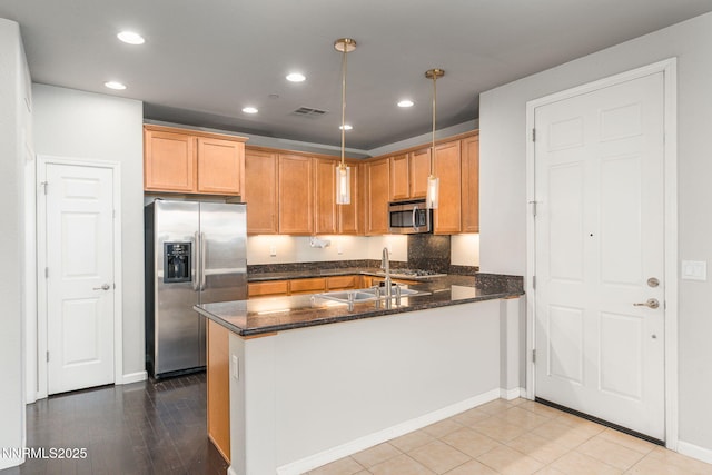 1875 Wind Ranch Rd Unit A, Reno, NV 89521 - kitchen featuring stainless steel appliances, a peninsula, a sink, recessed lighting, and dark stone countertops