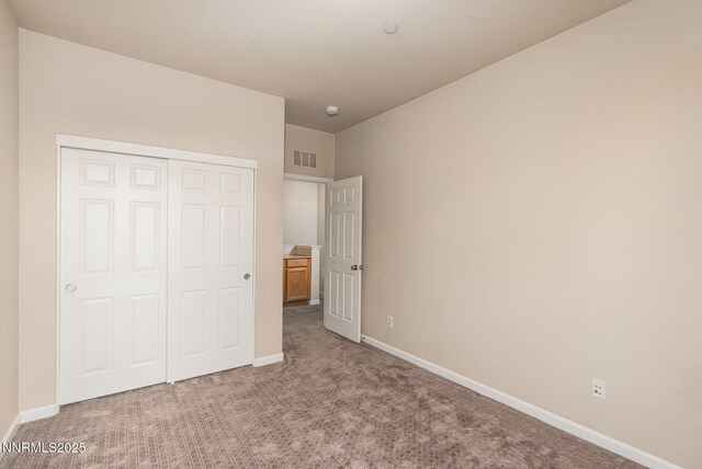 1875 Wind Ranch Rd Unit A, Reno, NV 89521 - unfurnished bedroom with carpet, baseboards, and a closet