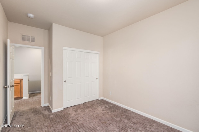 1875 Wind Ranch Rd Unit A, Reno, NV 89521 - unfurnished bedroom featuring dark colored carpet, baseboards, and a closet