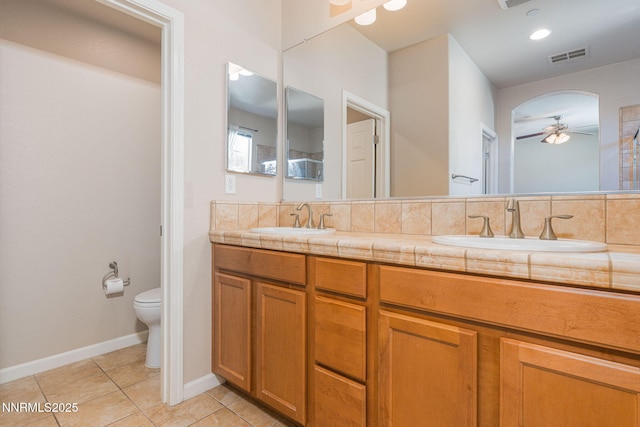 1875 Wind Ranch Rd Unit A, Reno, NV 89521 - bathroom featuring a ceiling fan, toilet, double vanity, tile patterned flooring, and baseboards