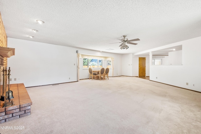 2196 Pebble Beach Dr, Reno, NV 89502 - unfurnished living room with a ceiling fan, a textured ceiling, carpet flooring, a fireplace, and baseboards