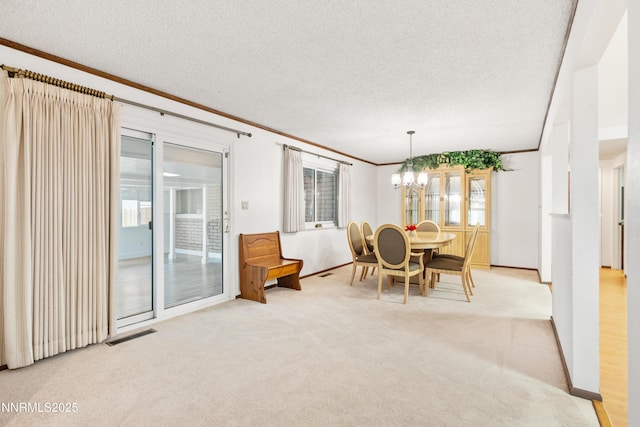 2196 Pebble Beach Dr, Reno, NV 89502 - dining area featuring crown molding, light colored carpet, a chandelier, baseboards, and a textured ceiling