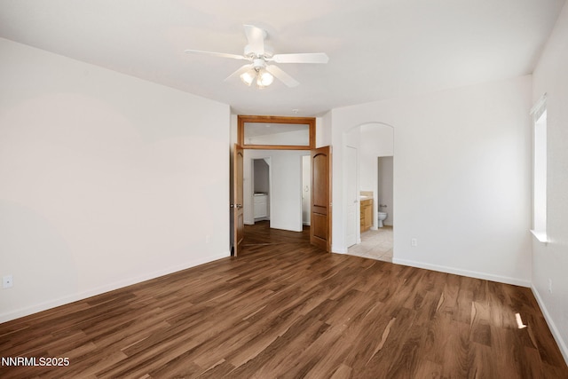 7145 Beacon Dr, Reno, NV 89506 - empty room featuring wood finished floors, arched walkways, ceiling fan, and baseboards