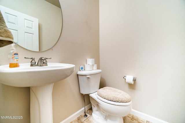 211 Jimmys Peak Ct, Fernley, NV 89408 - bathroom featuring toilet, baseboards, and a sink