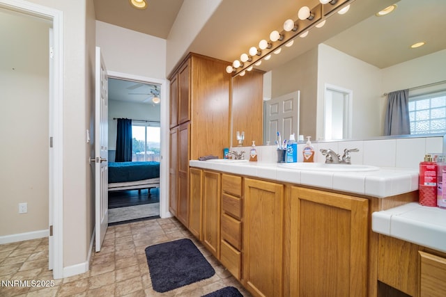 211 Jimmys Peak Ct, Fernley, NV 89408 - full bathroom featuring plenty of natural light, double vanity, ceiling fan, and stone finish floors