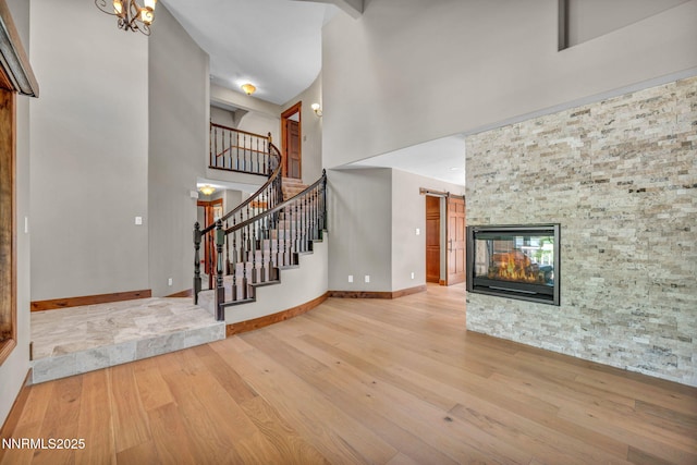 4215 Wild Eagle Ter, Reno, NV 89511 - unfurnished living room featuring wood finished floors, a high ceiling, and stairs