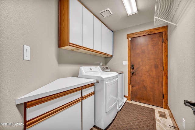 4215 Wild Eagle Ter, Reno, NV 89511 - laundry area with cabinet space, independent washer and dryer, and a textured wall