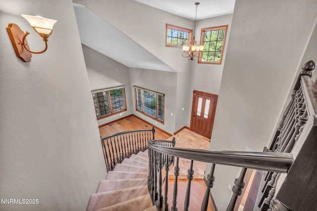 4215 Wild Eagle Ter, Reno, NV 89511 - stairs with a chandelier, wood finished floors, and a high ceiling