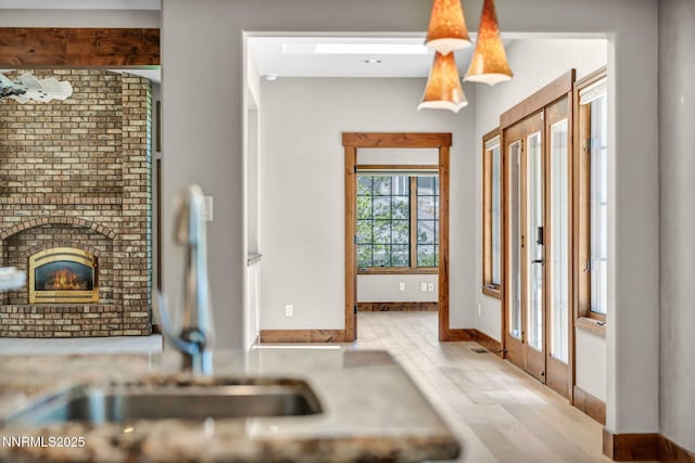 4215 Wild Eagle Ter, Reno, NV 89511 - kitchen featuring wood finished floors and a brick fireplace