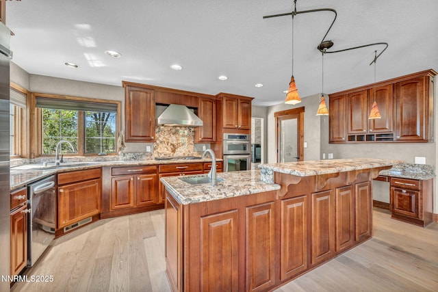 4215 Wild Eagle Ter, Reno, NV 89511 - kitchen with extractor fan, stainless steel appliances, light wood-style flooring, light stone countertops, and recessed lighting