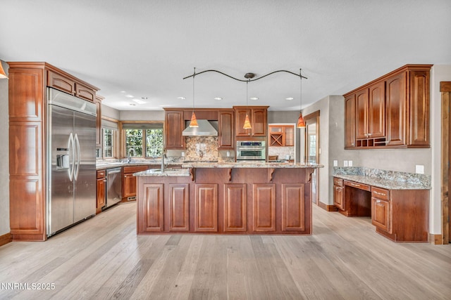4215 Wild Eagle Ter, Reno, NV 89511 - kitchen featuring stainless steel appliances, light wood-style floors, wall chimney exhaust hood, a center island with sink, and tasteful backsplash