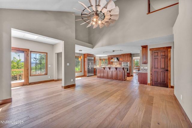 4215 Wild Eagle Ter, Reno, NV 89511 - unfurnished living room with high vaulted ceiling and light wood-style flooring