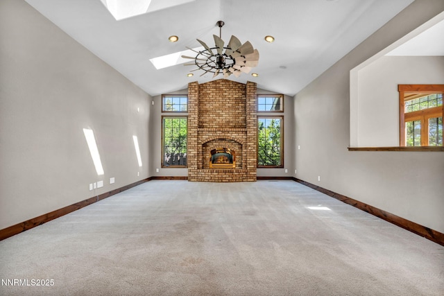 4215 Wild Eagle Ter, Reno, NV 89511 - unfurnished living room featuring a skylight, carpet flooring, a brick fireplace, a ceiling fan, and high vaulted ceiling