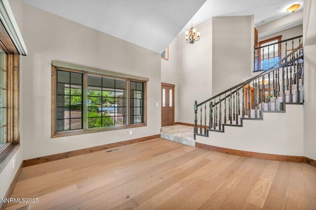 4215 Wild Eagle Ter, Reno, NV 89511 - foyer entrance featuring wood-type flooring, stairs, a chandelier, and a towering ceiling