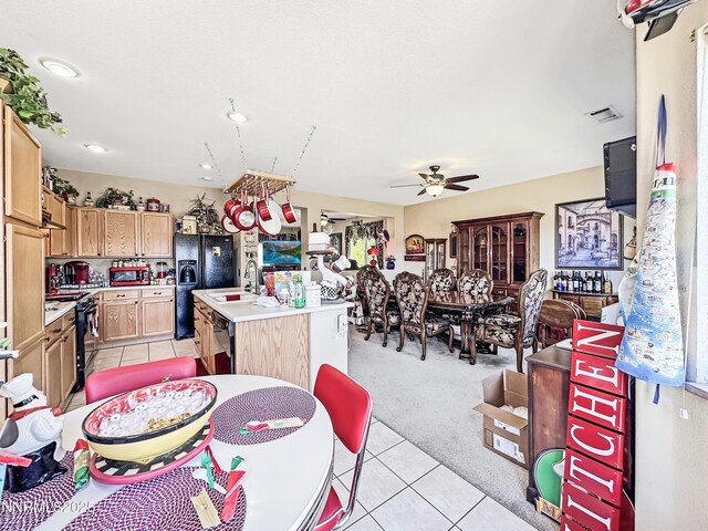 8490 Coral Reef Dr, Reno, NV 89506 - dining area featuring light tile patterned floors, a ceiling fan, and light colored carpet