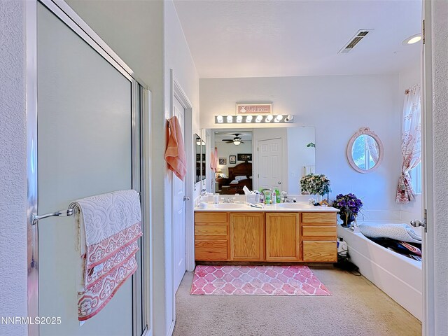 8490 Coral Reef Dr, Reno, NV 89506 - ensuite bathroom featuring a garden tub, a shower stall, double vanity, and a ceiling fan