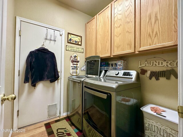 8490 Coral Reef Dr, Reno, NV 89506 - washroom featuring cabinet space, washing machine and clothes dryer, and wood finished floors