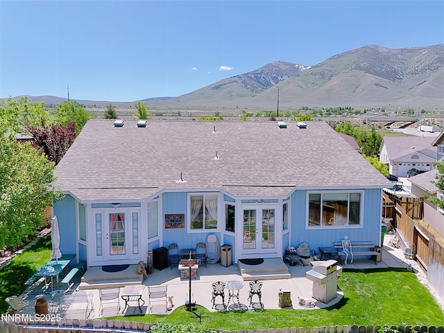 8490 Coral Reef Dr, Reno, NV 89506 - back of house featuring roof with shingles, french doors, a patio area, and a fenced backyard