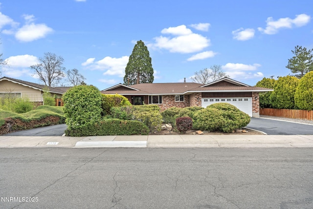 1495 Lillian Way, Reno, NV 89509 - ranch-style house with asphalt driveway, a garage, and brick siding