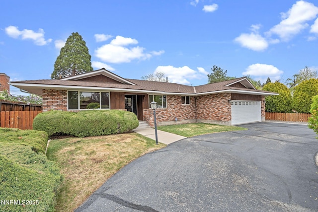 1495 Lillian Way, Reno, NV 89509 - single story home featuring a garage, driveway, brick siding, and roof with shingles