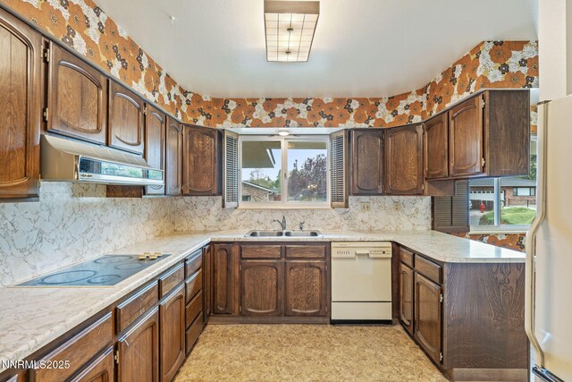 1495 Lillian Way, Reno, NV 89509 - kitchen featuring a sink, white appliances, and light countertops
