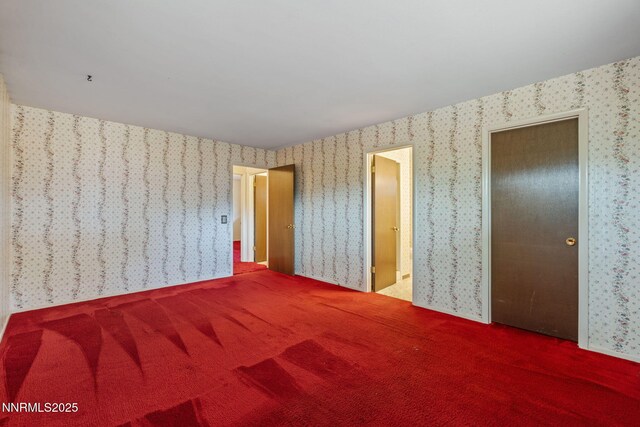 1495 Lillian Way, Reno, NV 89509 - unfurnished bedroom featuring wallpapered walls, carpet floors, and ensuite bathroom