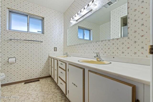 1495 Lillian Way, Reno, NV 89509 - bathroom featuring double vanity, wallpapered walls, toilet, and baseboards